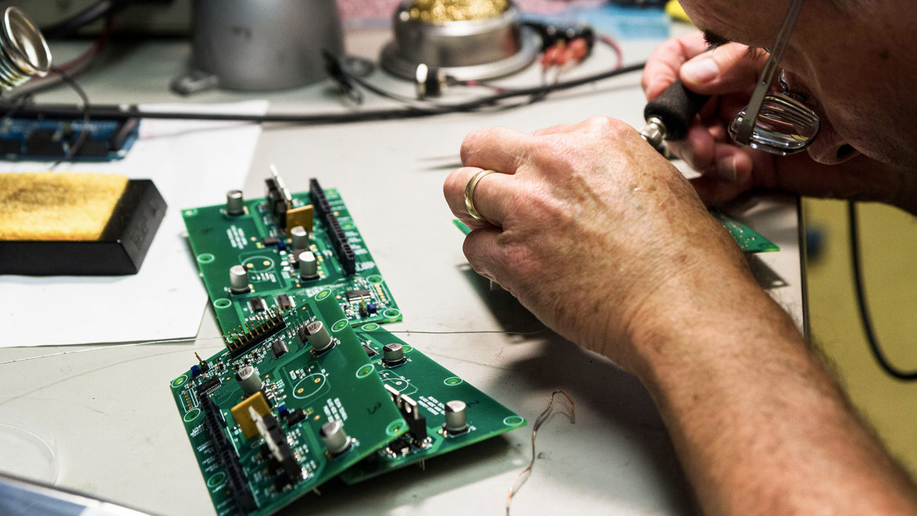 electrical engineer soldering prototype pcb assemblies